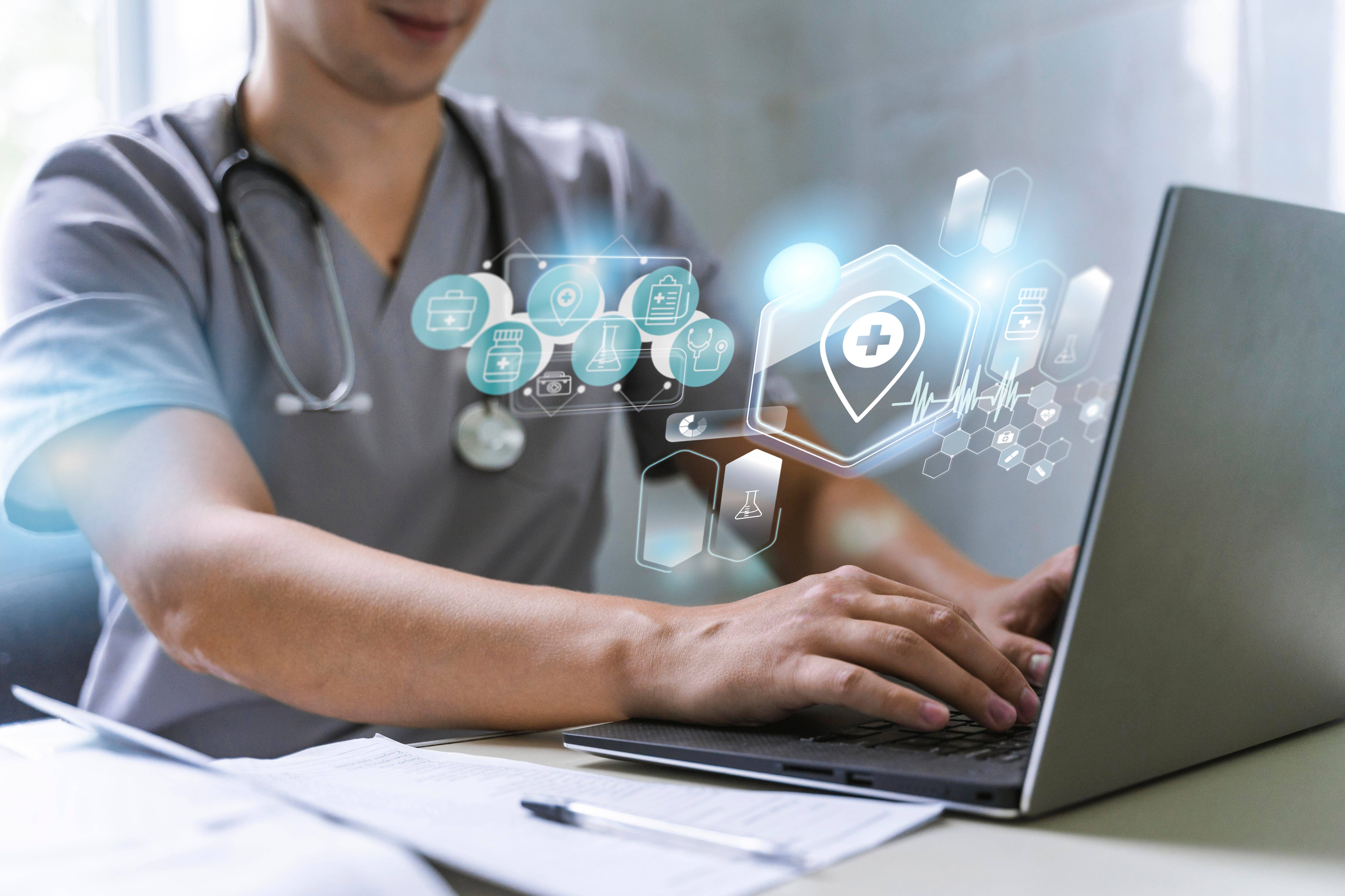 Healthcare professional working on laptop with digital health icons